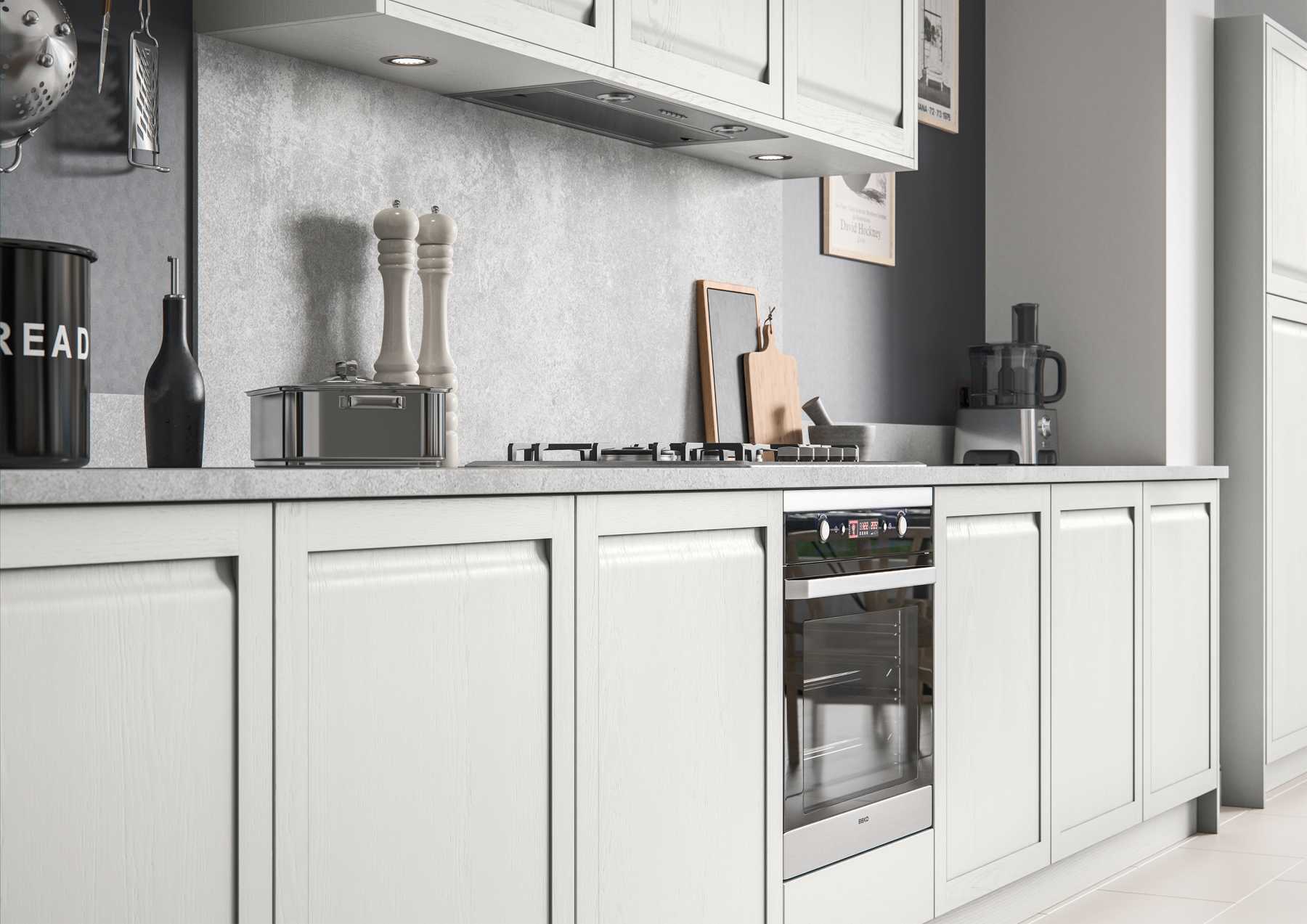 Contemporary handleless shaker style kitchen base units painted matte light grey