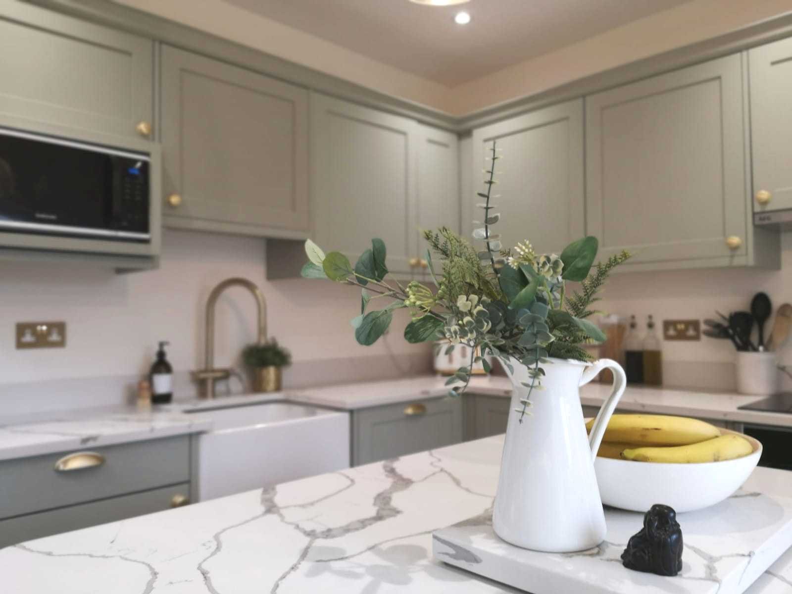 contemporary shaker style kitchen view across kitchen island top with calacatta borgo quartz
