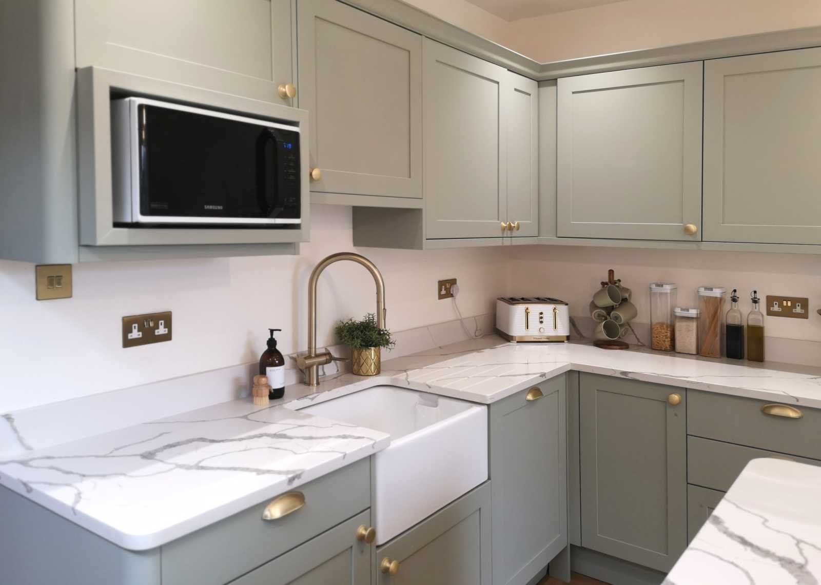 contemporary shaker style kitchen showing belfast sink and brass tap