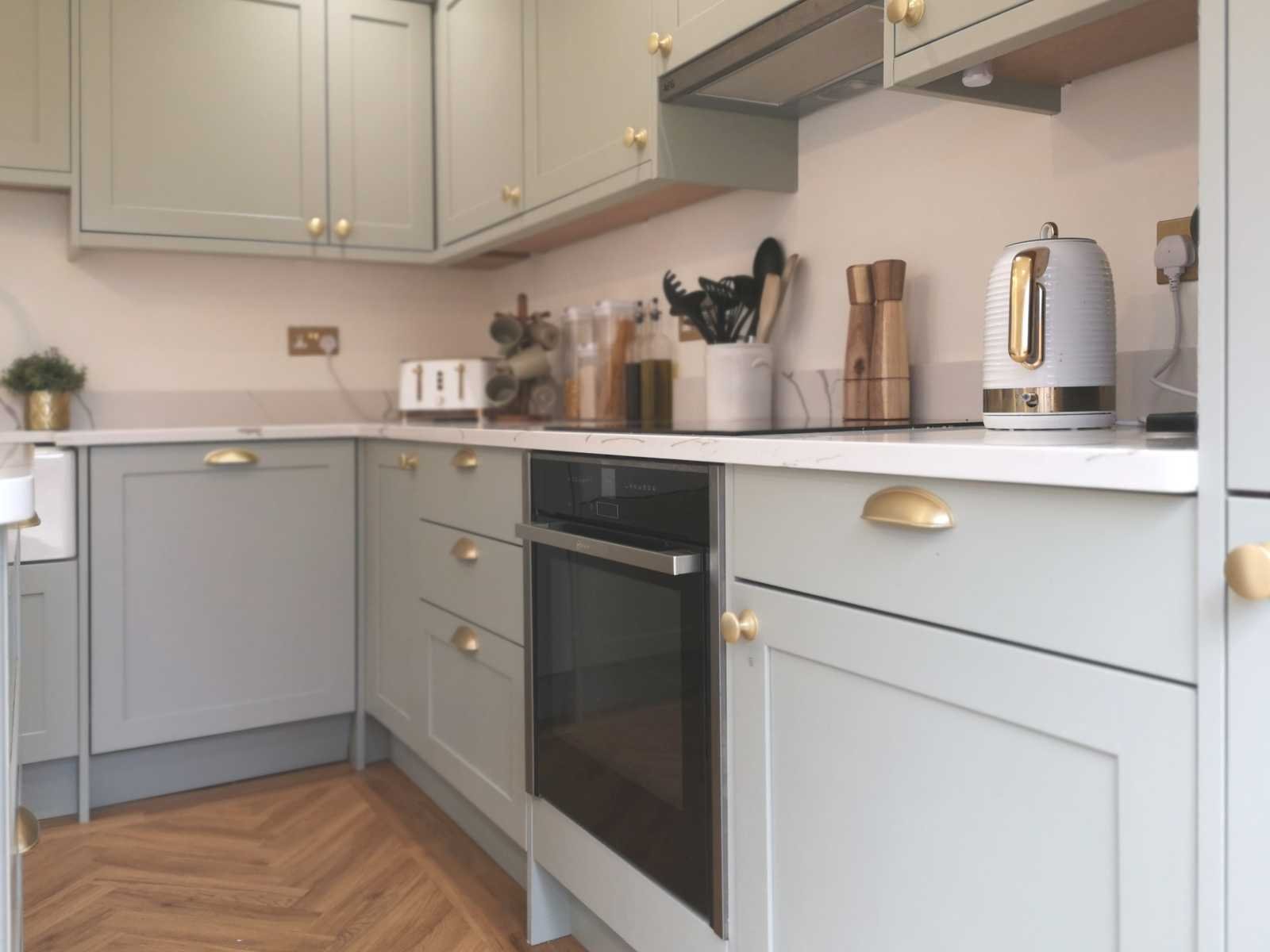 contemporary shaker style solid wood kitchen in matte sage green close up