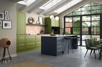 Handleless Shaker-Style Kitchen Painted Slate Blue and Citrus Green featuring island unit with pendant lighting, bare brick backsplash and dining area 